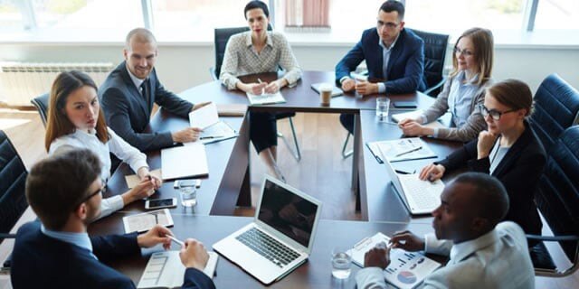 business group sitting around conference table